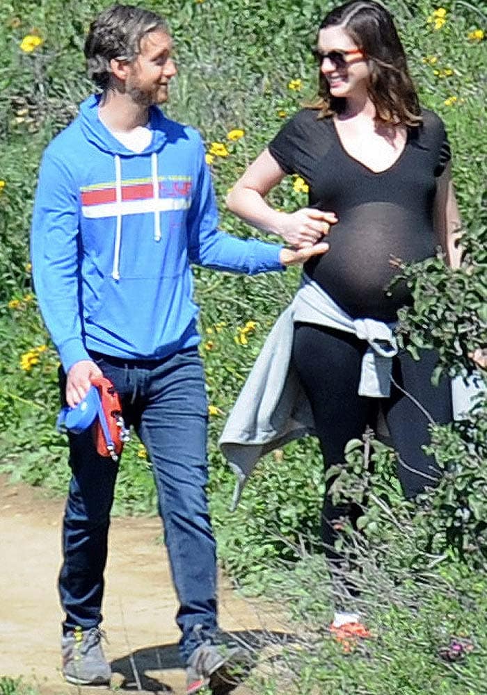 Anne Hathaway's husband Adam Shulman touches the actress's growing baby belly