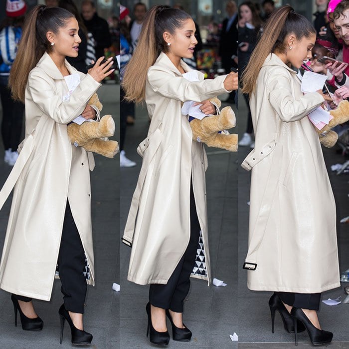 Ariana Grande wears a Dawn Levy trench coat over a Self-Portrait jumpsuit