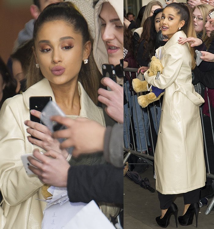 Ariana Grande poses for selfies and signs autographs for fans outside of the BBC Radio 1 studios in London