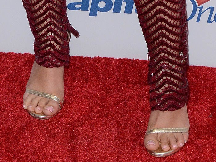 Ariel Winter's feet in strappy gold Stuart Weitzman sandals