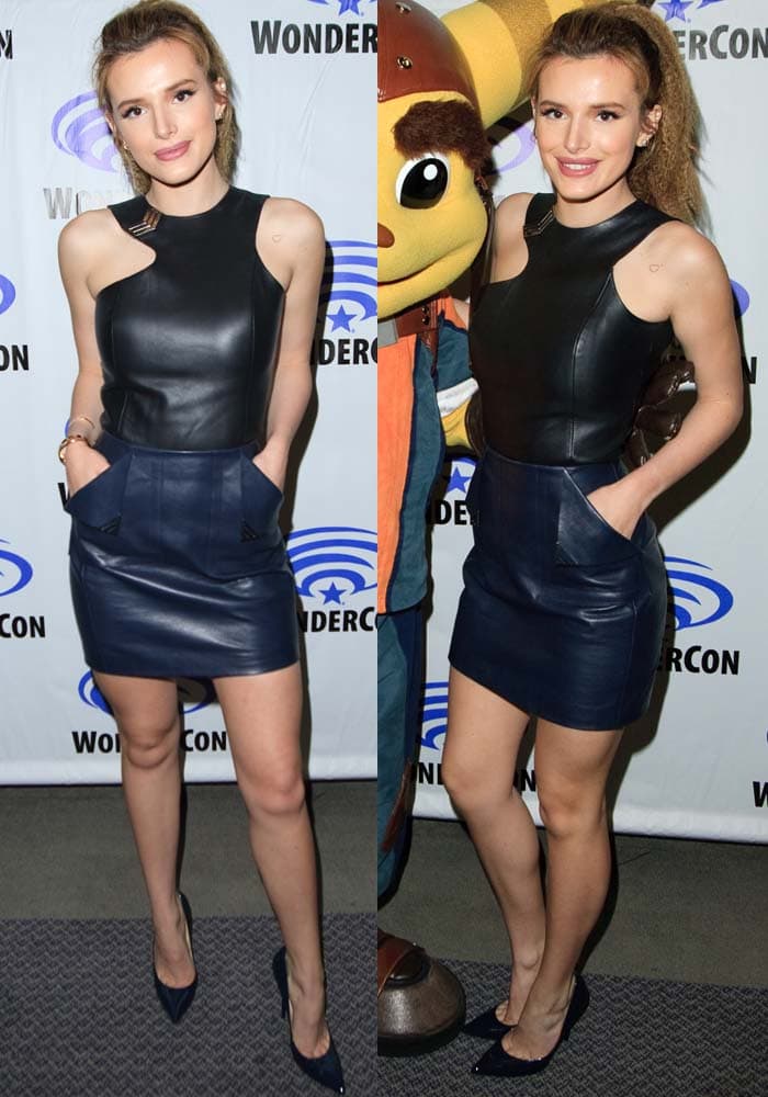 Bella Thorne wears a black leather halter top with a navy leather Mugler mini skirt