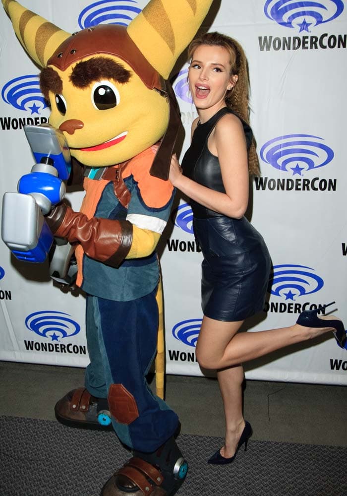 Bella Thorne poses with a Ratchet mascot as she promotes her latest animated film, "Ratchet & Clank"