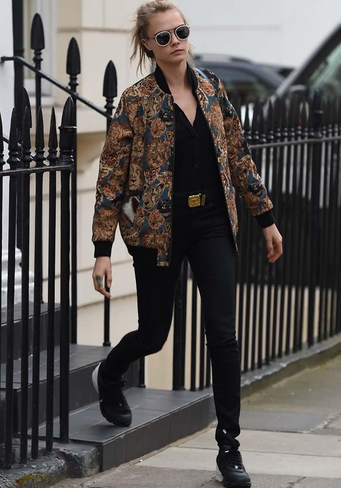 Cara Delevingne wears a Saint Laurent bomber jacket as she leaves her parents' house in London