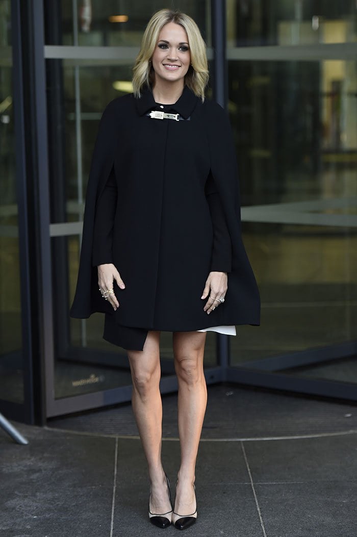 Carrie Underwood wears a black Kate Spade coat in Manchester