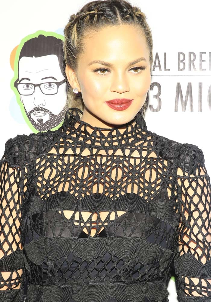 Chrissy Teigen braids her hair for the opening night for "Neal Brennen 3 Mics" presented by John Legend and Get Lifted Film Company