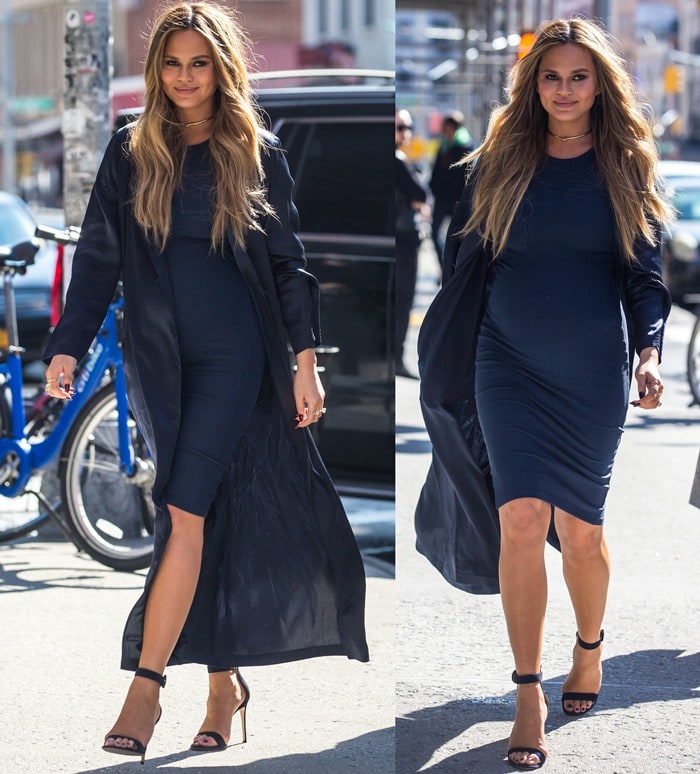 Chrissy Teigen shows off her growing baby bump in a fitted blue dress from Nadia Tarr