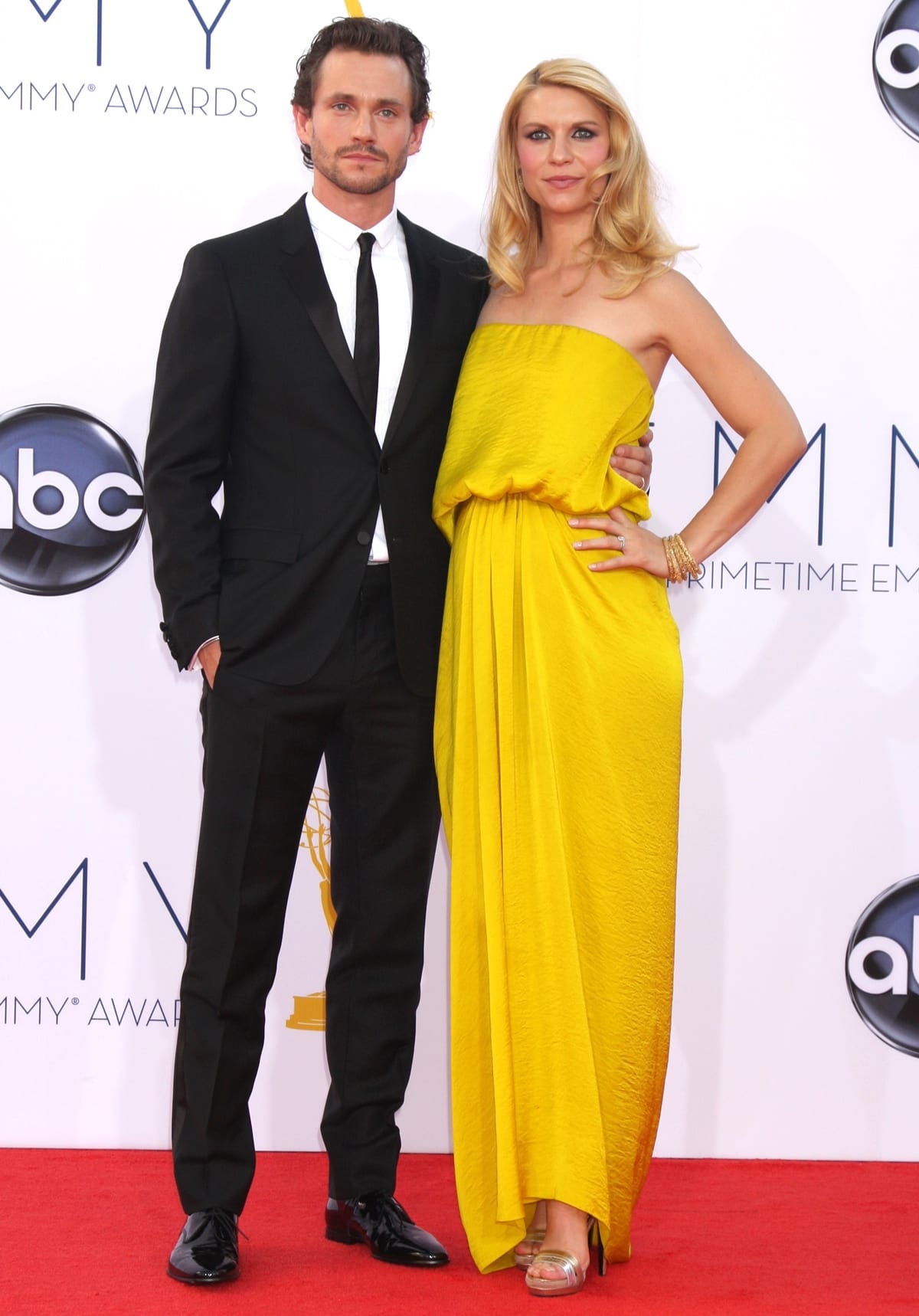 Claire Danes showed off her baby bump in a canary yellow Lanvin dress with her husband Hugh Dancy