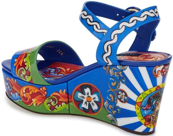 A stunning, scene-stealing wedge sandal is shaped from supple leather and colored in a vibrant, ornate baroque pattern for a modern look inspired by historically rich designs