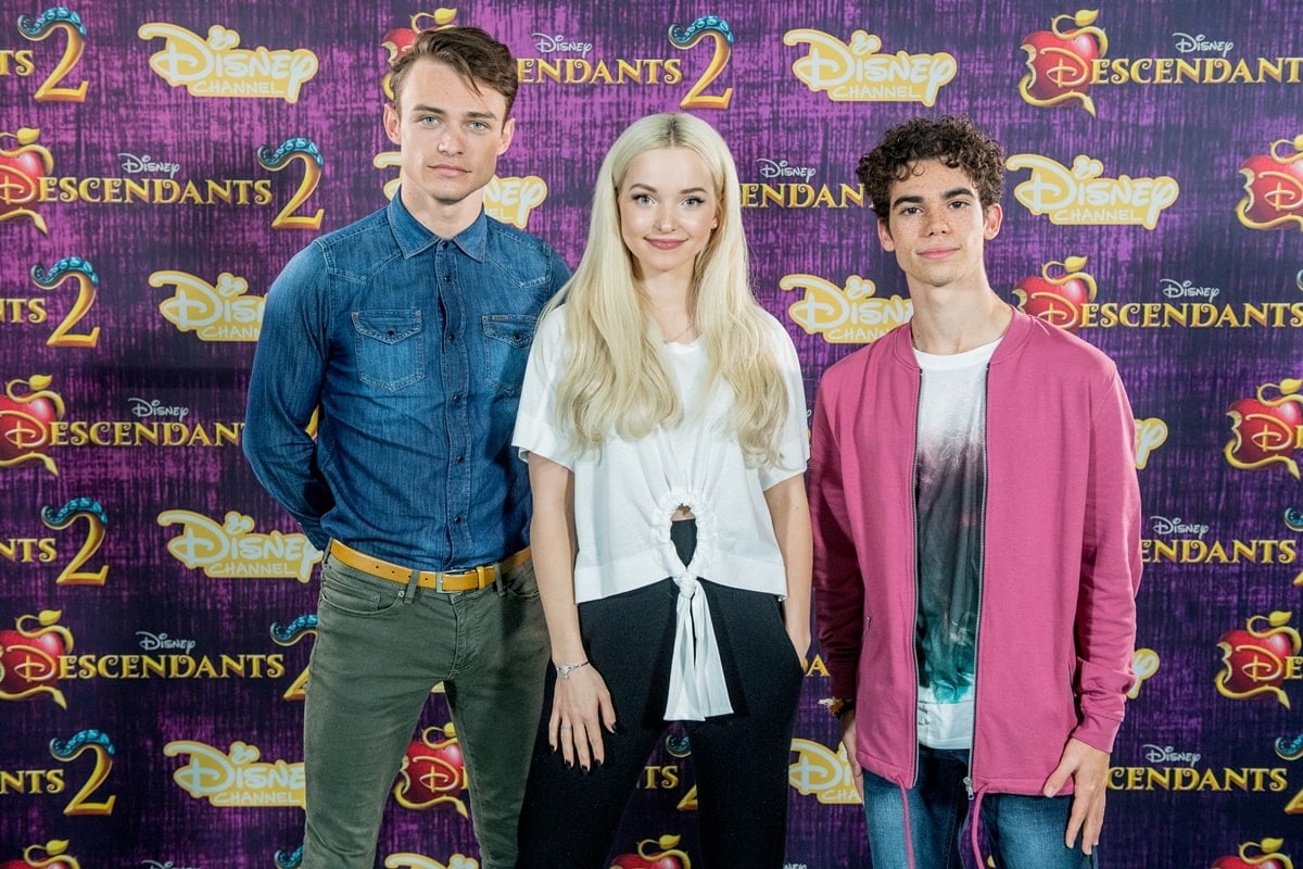 Dove Cameron poses with Thomas Doherty and Cameron Boyce at the Descendants 2 photocall