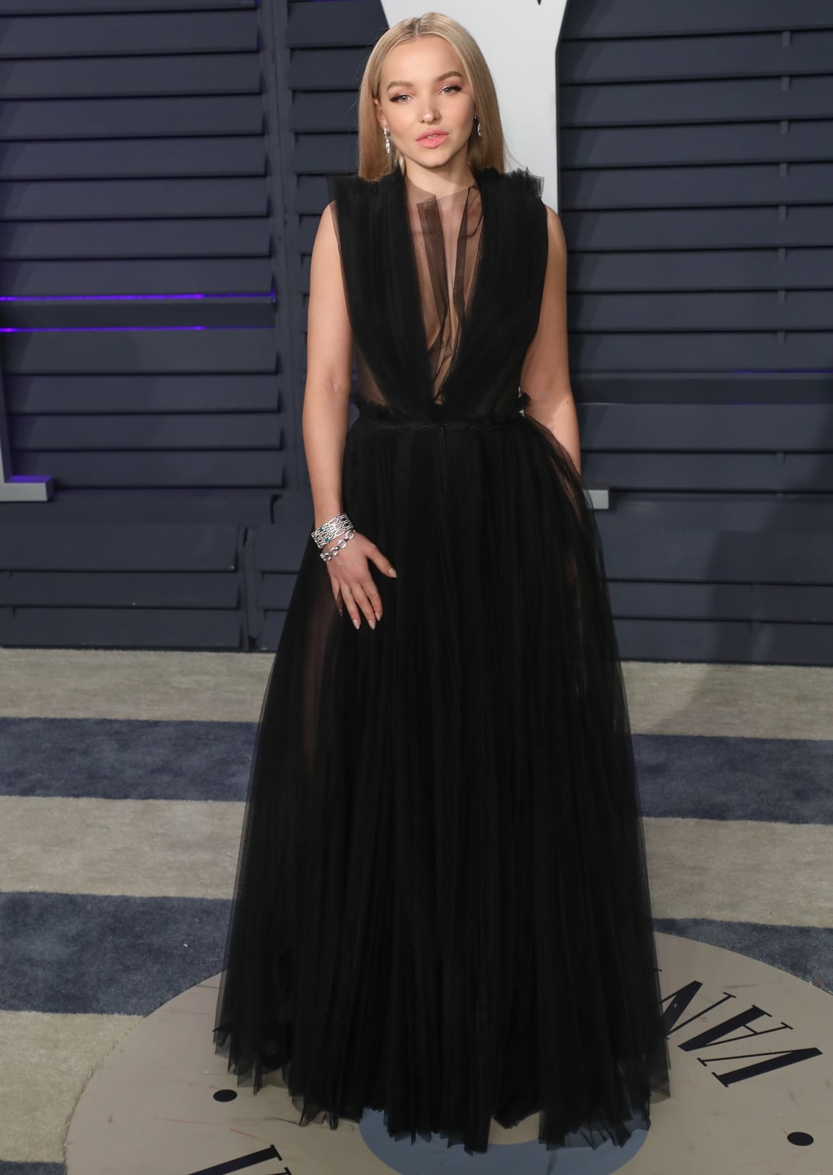 Dove Cameron in a black Adeam gown with Serpenti earrings and a Serpenti bracelet by Bulgari at the 2019 Vanity Fair Oscar Party