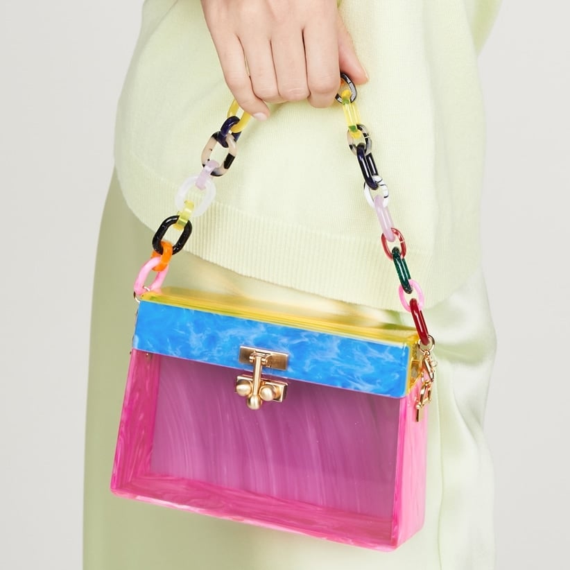 This multicolor Edie Parker bag features a moirè effect and a boxy silhouette with a gold-tone clasp