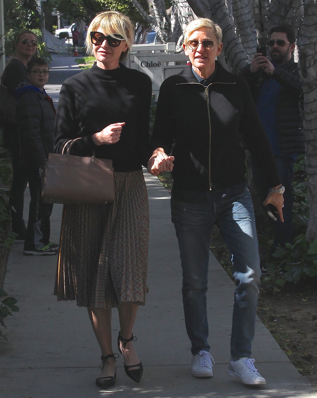 Ellen DeGeneres and her wife Portia de Rossi hold hands as they stroll Melrose Place