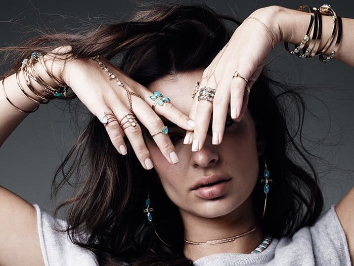 Emily Ratajkowski showcases her boho-chic style, layering delicate rings, bracelets, and earrings from Jacquie Aiche for an effortlessly cool look