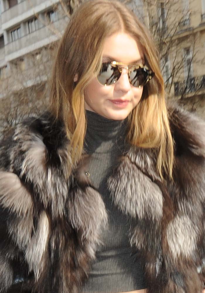 Gigi Hadid wears her hair down as she arrives at the Four Seasons George V Hotel in Paris