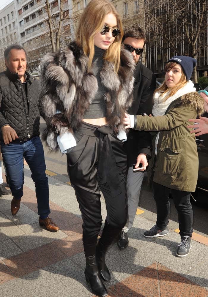 Gigi Hadid wears a gray fur Waldrip coat with black pants