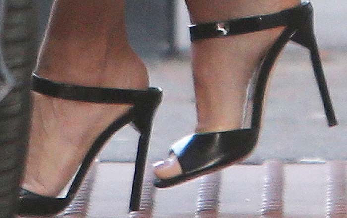 Heidi Klum's feet in black leather Jimmy Choo sandals