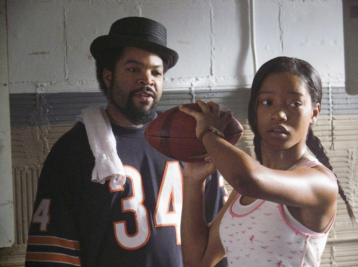Keke Palmer and Ice Cube in a scene from The Longshots (2008), where Palmer portrays Jasmine Plummer, the first female quarterback in Pop Warner football history