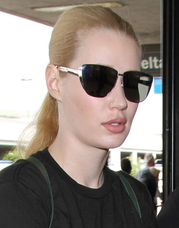Iggy Azalea wears her hair in a ponytail as she arrives at Los Angeles International Airport