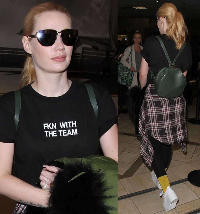 Iggy Azalea accessorizes with dark sunglasses and a green backpack