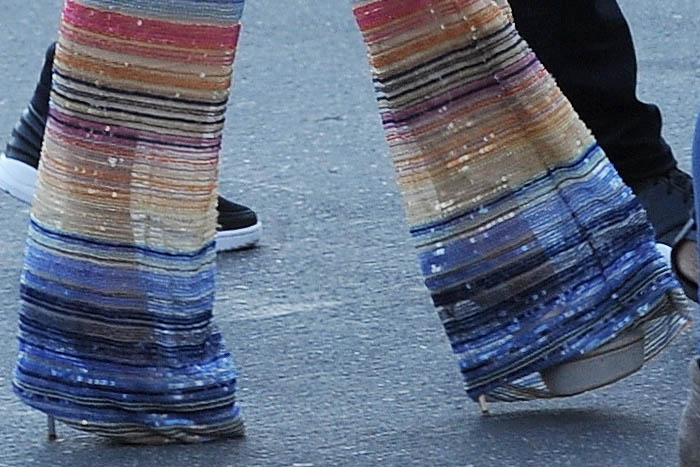 Jennifer Lopez boosted her height with Casadei Blade platform pumps, which were perfectly hidden beneath the bell-bottoms of her vibrant, striped jumpsuit
