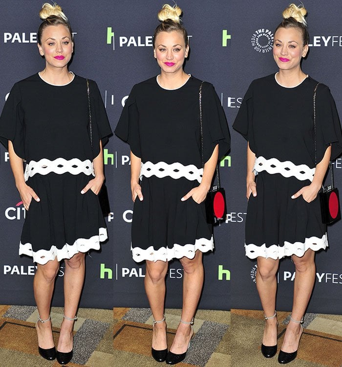Kaley Cuoco carries a red-embellished bag and wears bright pink lipstick