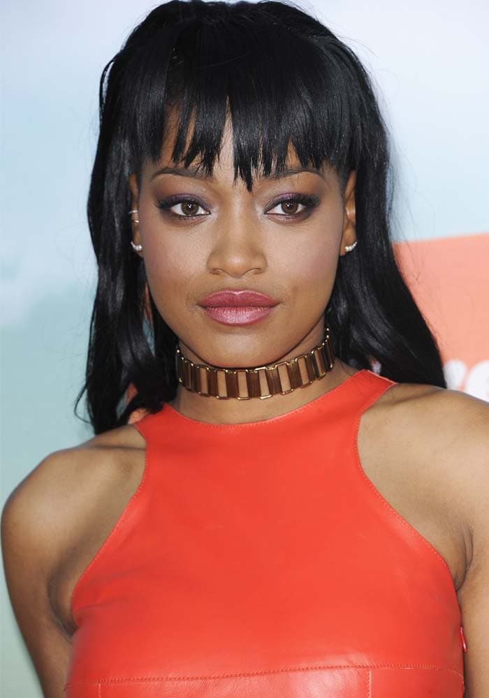 Keke Palmer exudes confidence in a bold orange leather top paired with a sleek gold choker