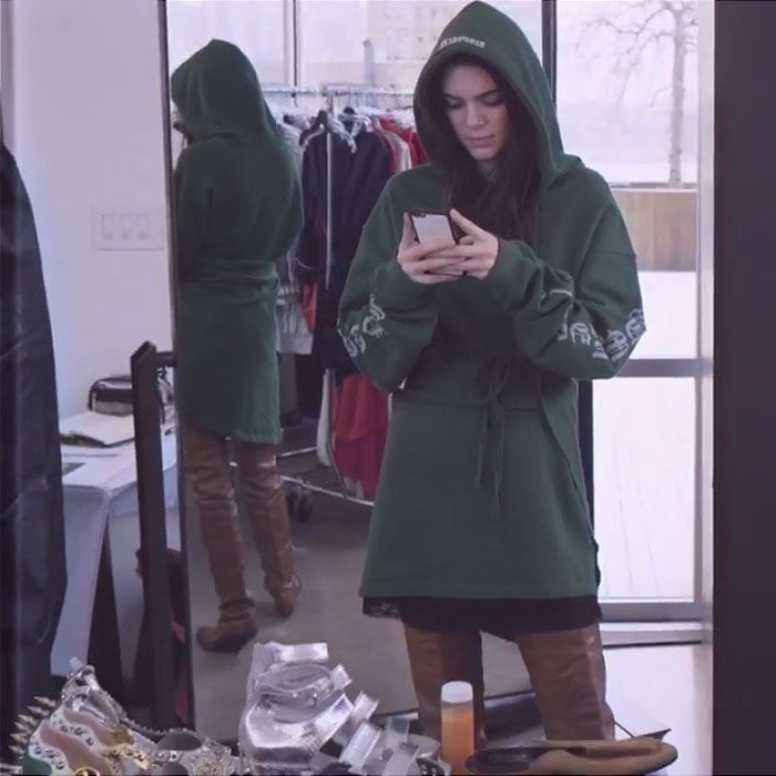 Kendall Jenner pairs a green hoodie with thigh-high Vetements boots