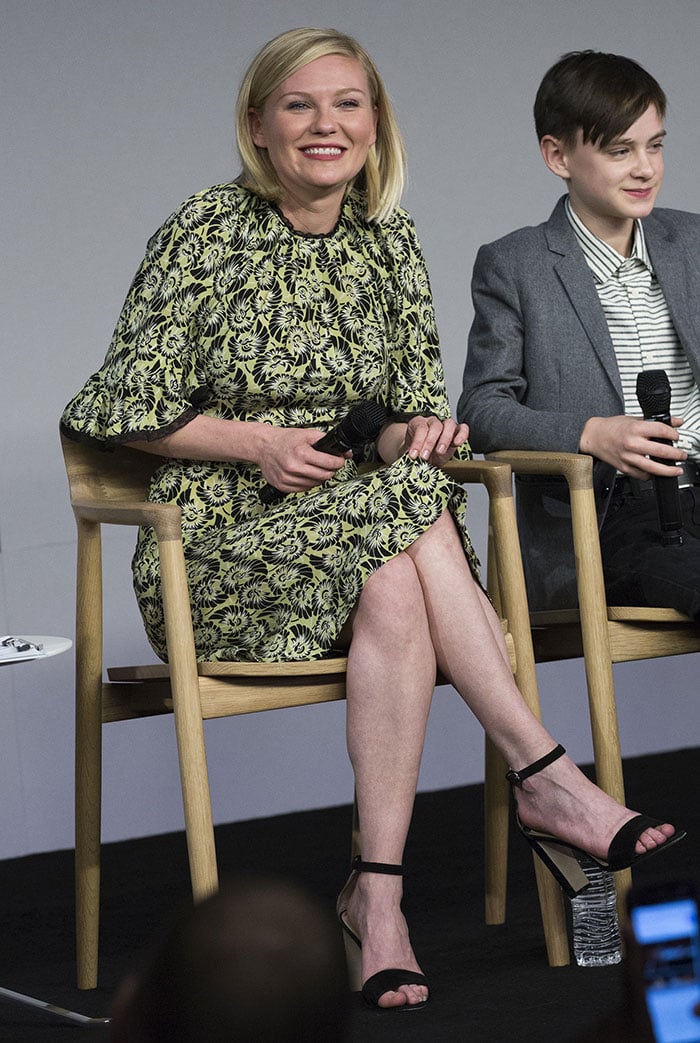 Kirsten Dunst wears a lime-green-and-black dress during an Apple Store event