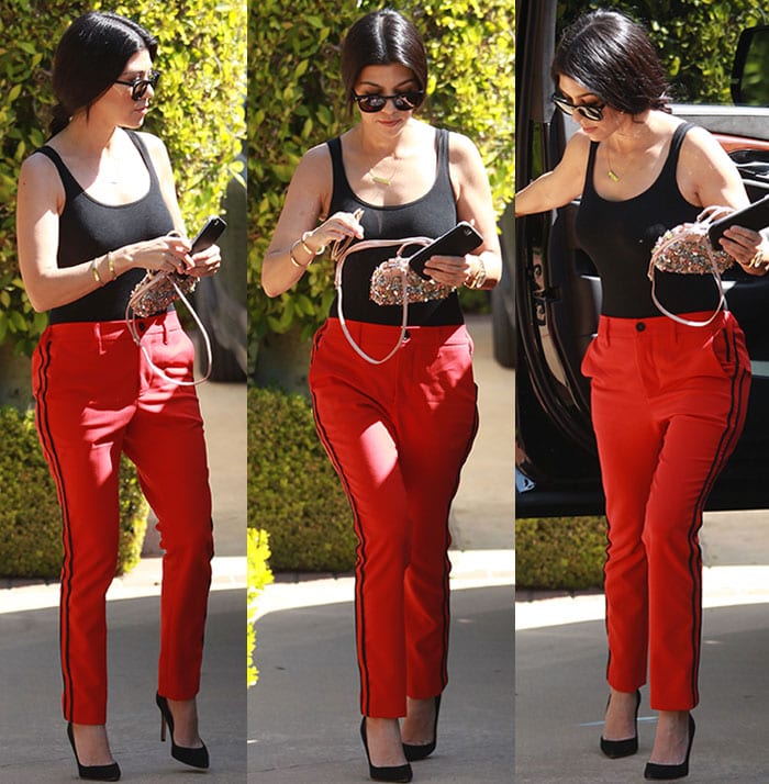 Kourtney Kardashian wears a Wolford top and Zadig & Voltaire pants