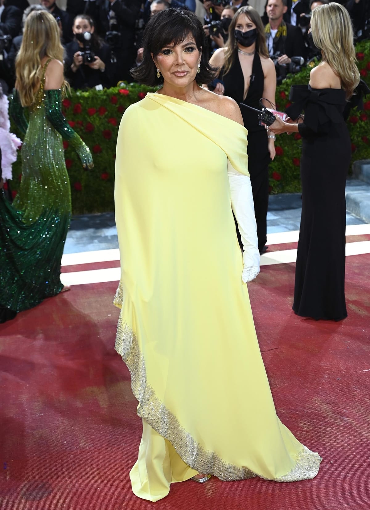 Kris Jenner in a silk yellow Oscar de la Renta dress at the 2022 Met Gala Celebrating "In America: An Anthology of Fashion"
