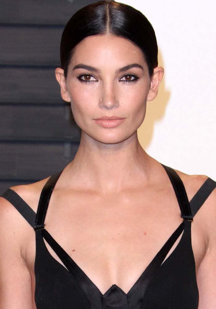 Lily Aldridge center parts her hair for the Vanity Fair Oscar Party