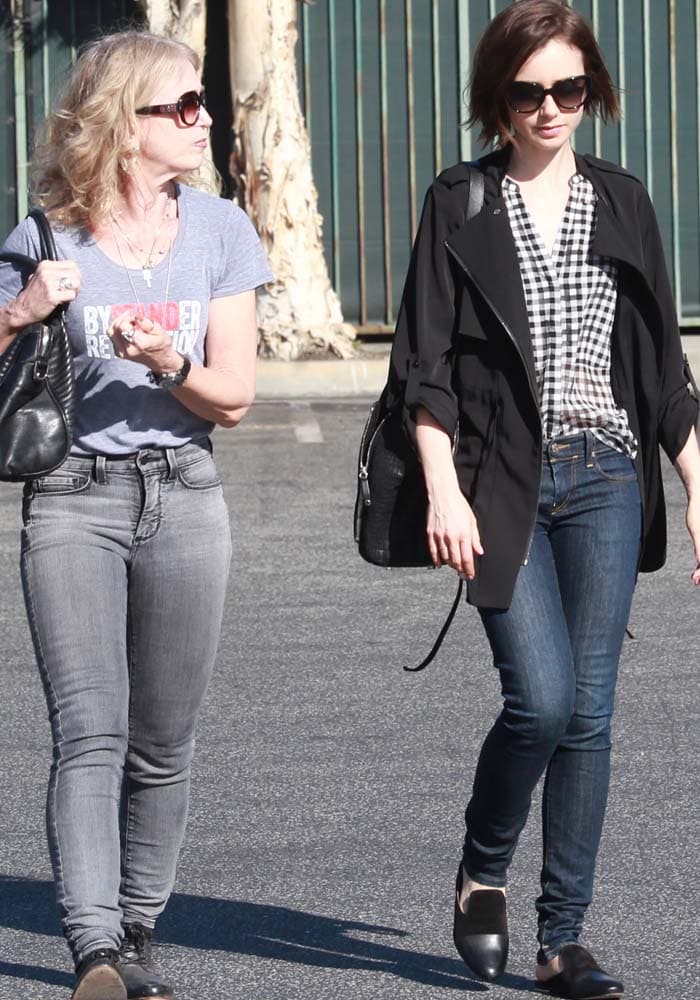 Jill Tavelman and daughter Lily Collins step out in casual-chic outfits, with Lily pairing a checkered blouse and sleek black jacket with dark skinny jeans and Rag & Bone ‘Sabine’ slip-on shoes for a polished yet effortless street style