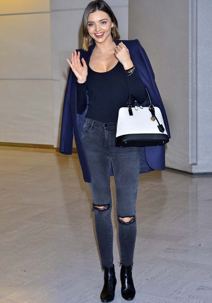 Miranda Kerr wears J Brand distressed jeans as she walks through Narita International Airport