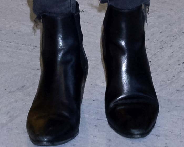 Miranda Kerr wears Saint Laurent ankle boots at the airport