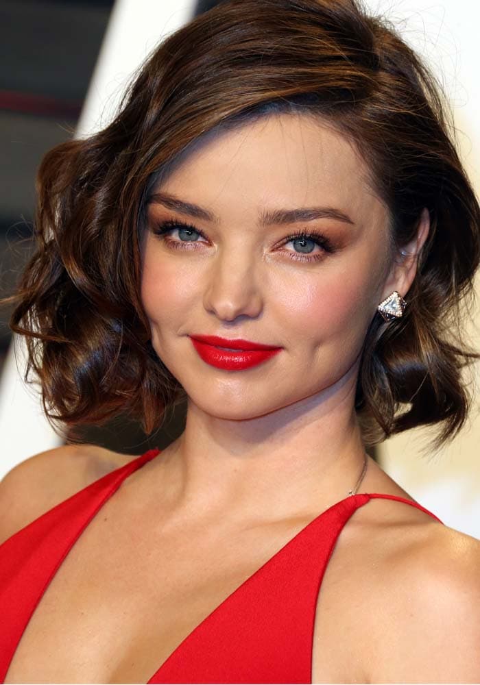 Miranda Kerr wears her dark hair in curls at the Vanity Fair Oscar Party