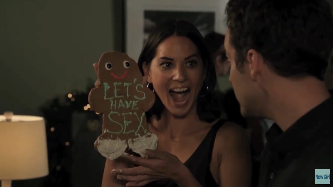 Olivia Munn as Nick's stripper girlfriend holds up a"Let's have sex" ginger cookie