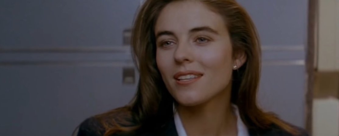 Elizabeth Hurley as sole henchwoman Sabrina Ritchie disguised as a flight attendant in the 1992 American action thriller film "Passenger 57"