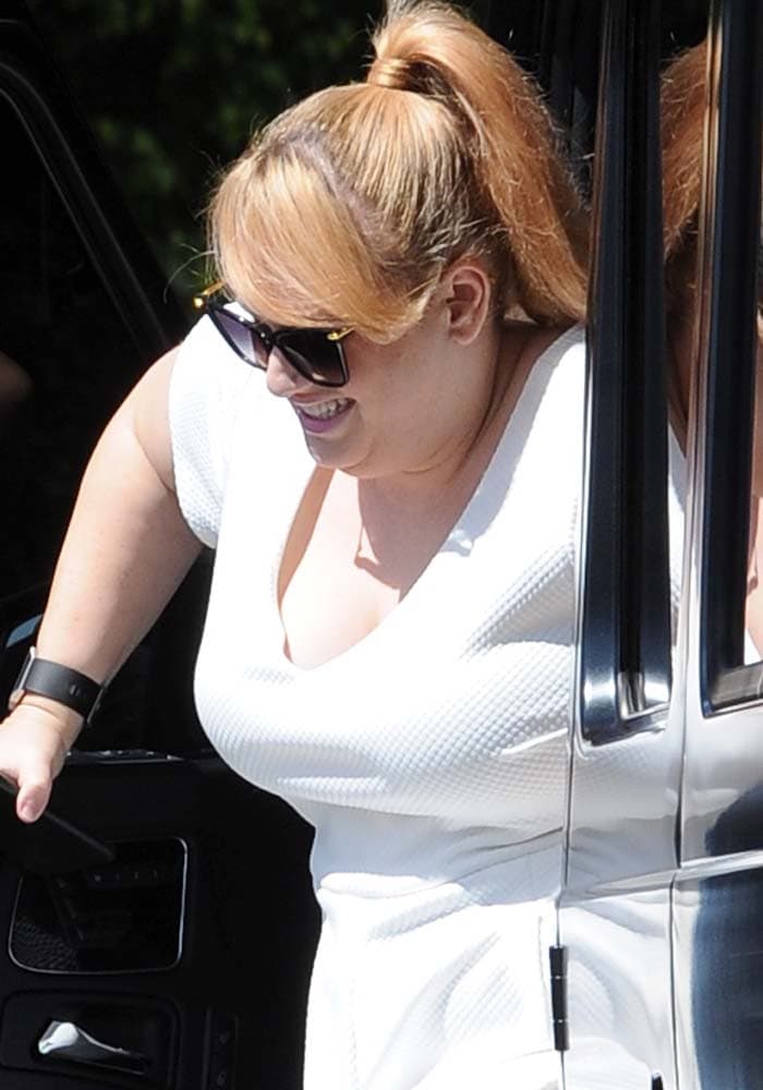 Rebel Wilson in a white fit-and-flare dress arrives for a lunch meeting at Chateau Marmont