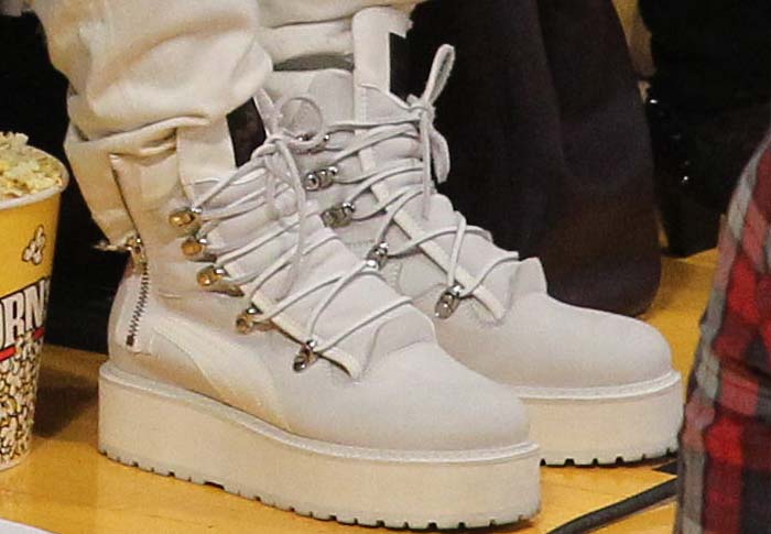 Rihanna wears a pair of Fenty x Puma boots court-side to an NBA game