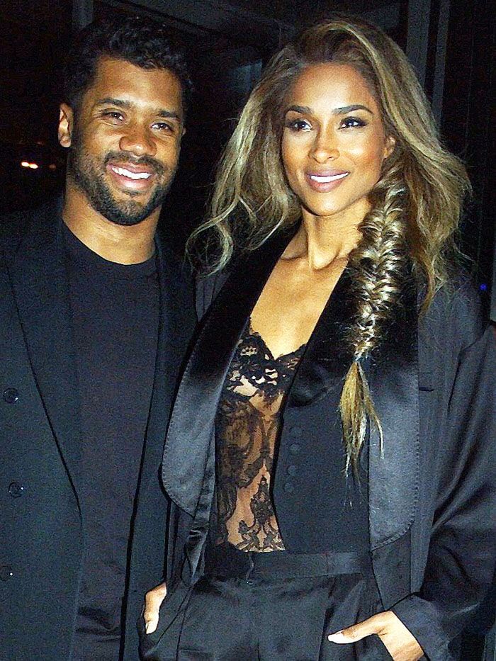 Russell Wilson and Ciara smile for photos during Paris Fashion Week