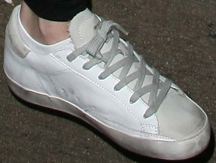 Selena Gomez puts on a pair of already-dirty "Superstar" sneakers by Golden Goose