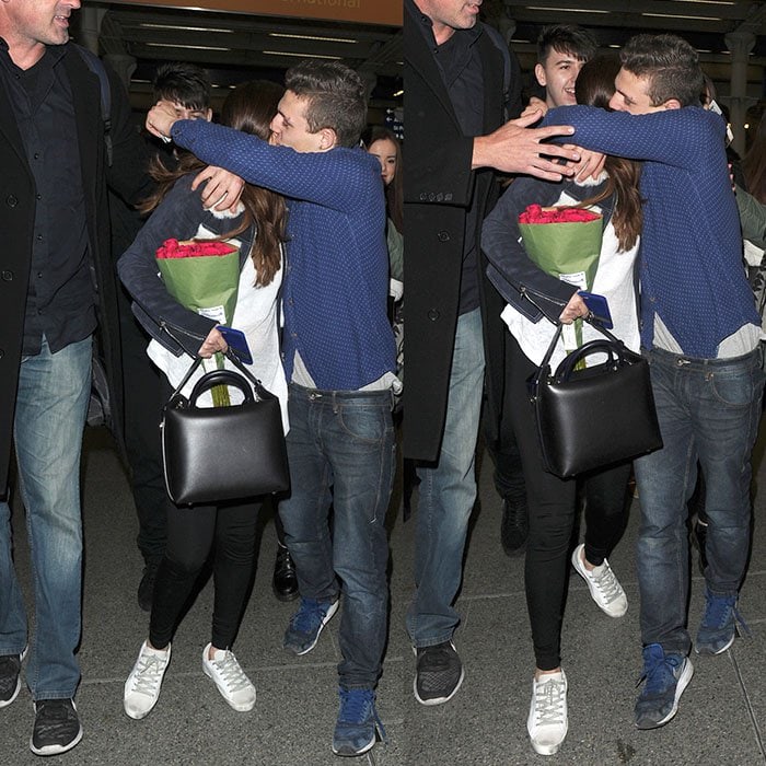 A male fan gives Selena Gomez a hug, which Selena's bodyguard quickly put a stop to