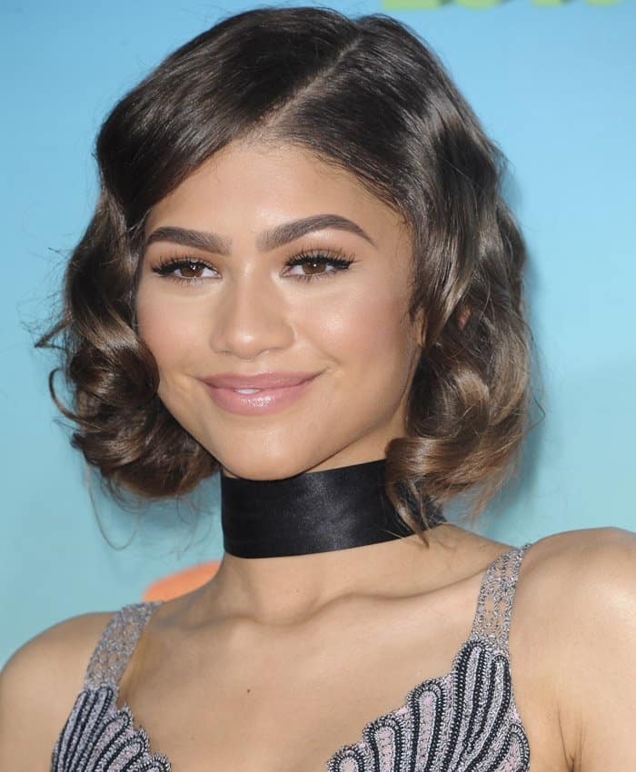 Zendaya's look is pure perfection with her soft, vintage-inspired waves and flawless makeup that highlights her natural beauty, complete with bold brows, defined lashes, and a subtle pink lip at the 2016 Nickelodeon Kids' Choice Awards