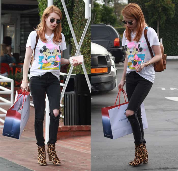 Emma Roberts steps out in a playful Mickey Mouse t-shirt, ripped skinny jeans, and eye-catching leopard print booties, showcasing her effortlessly chic casual style