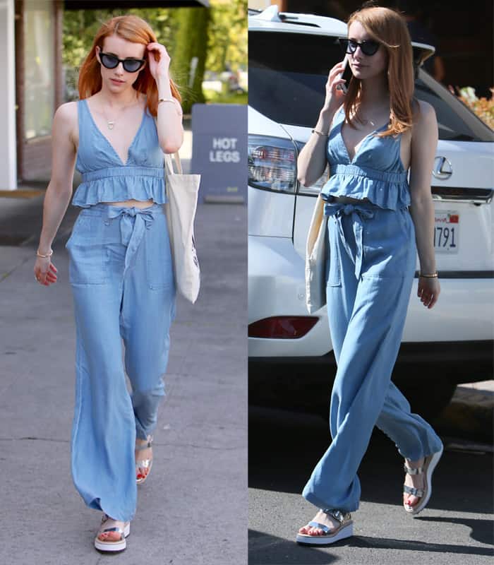 Emma Roberts rocks a light blue chambray jumpsuit, complete with a tie waist and ruffled top, perfectly blending casual comfort with chic style