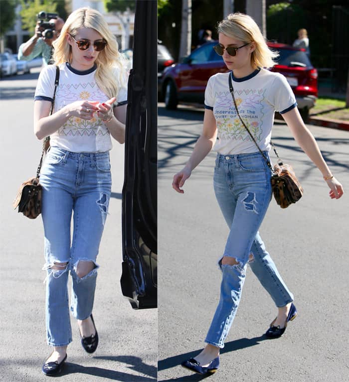 Emma Roberts looks effortlessly cool in a graphic ringer tee and high-waisted ripped jeans, paired with chic flats and a stylish crossbody bag