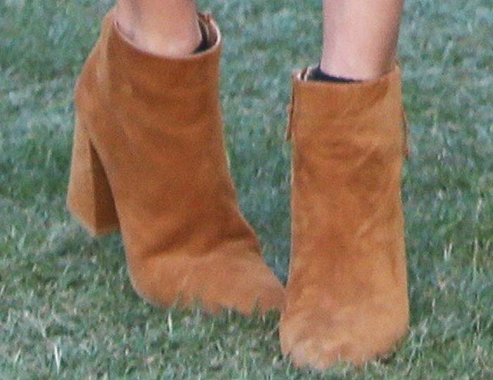 Alessandra Ambrosio wears a pair of Stuart Weitzman boots to Coachella