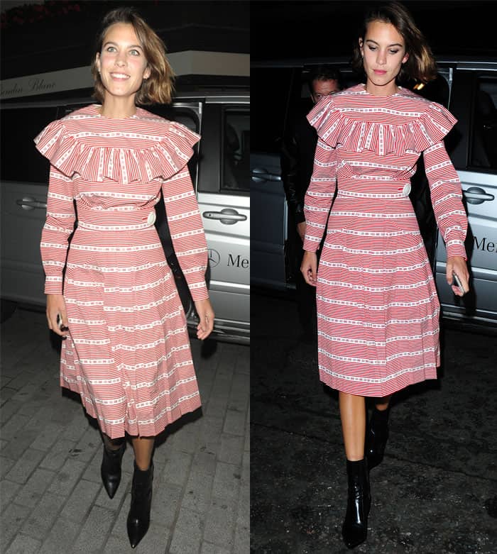 Alexa Chung embraces a vintage-inspired look in a red and white striped dress with a ruffled collar, adding a modern twist with black ankle boots while out in London