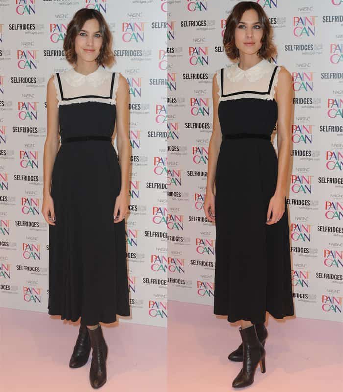 Alexa Chung exudes feminine sophistication in a classic black midi dress with a delicate white collar, completing the look with ankle boots for a modern touch at a Selfridges event