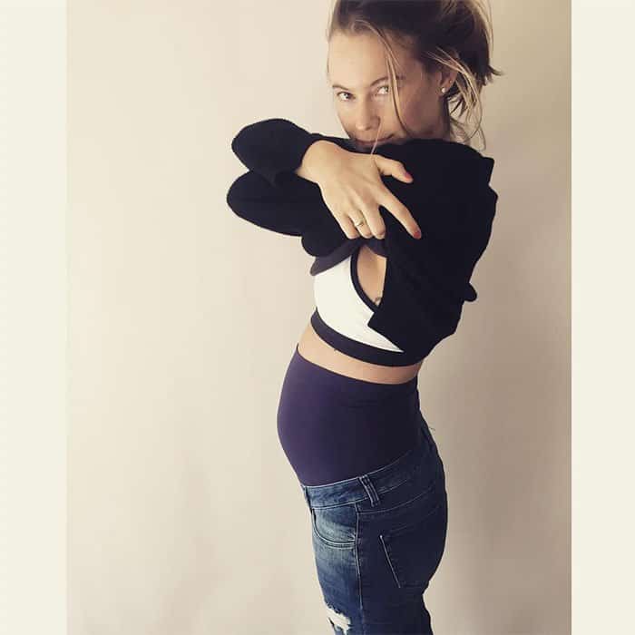Behati Prinsloo shows off her tiny baby bump in stylish maternity jeans and a comfy cropped sweater